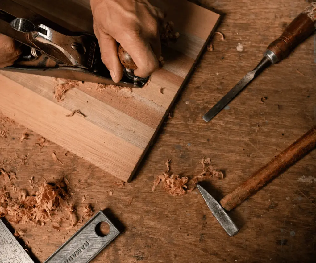 Carpenter chiseling wood joint