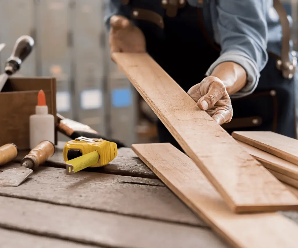 Carpenter measuring wooden plank