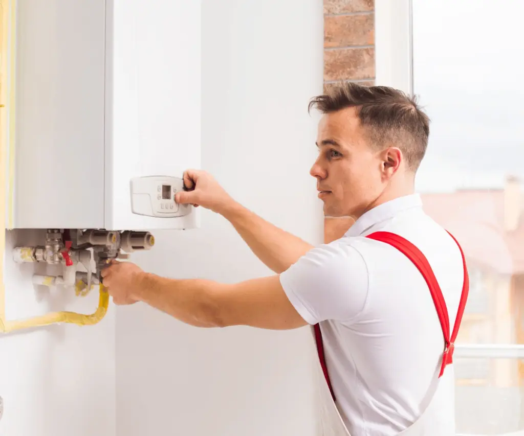 Heating engineer installing a new boiler in London home