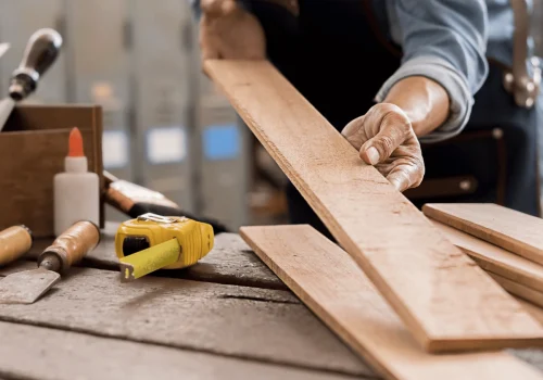 Carpenter measuring wooden plank
