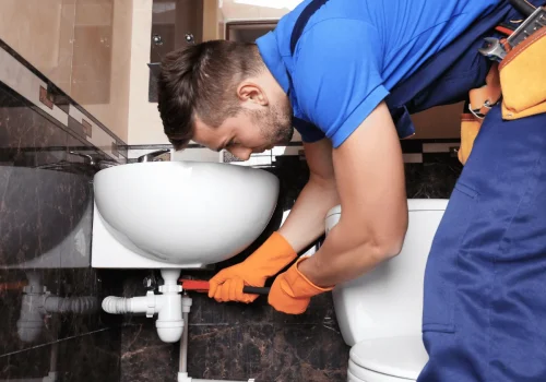 Plumber working on bathroom sink installatio